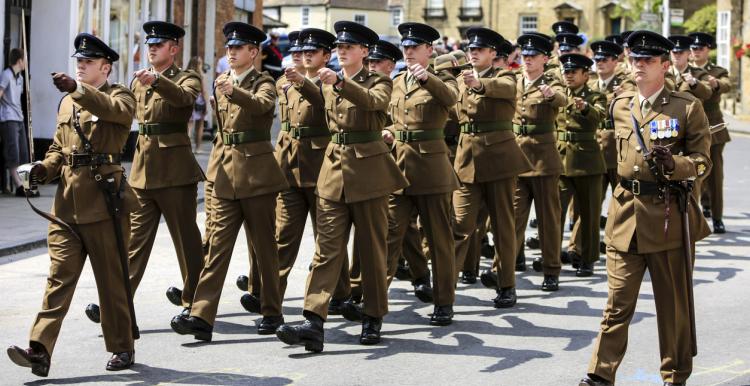 Group of soldiers marching in uniform in a British town