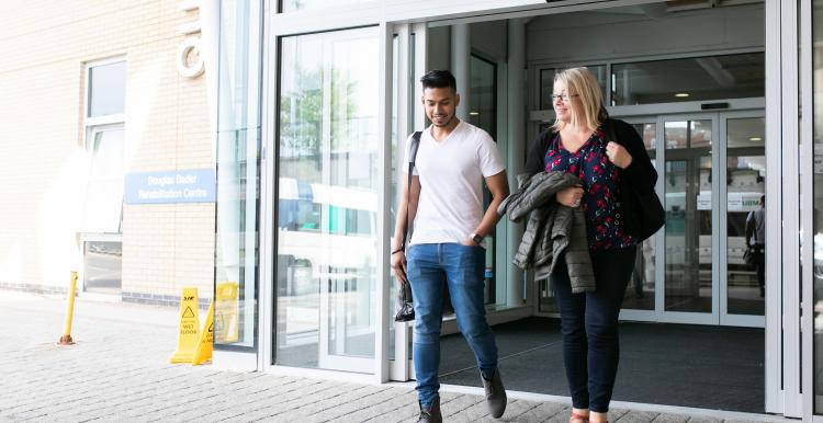 Two people leaving the hospital together