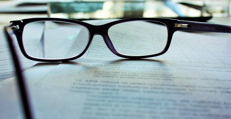 Black framed glasses on printed document