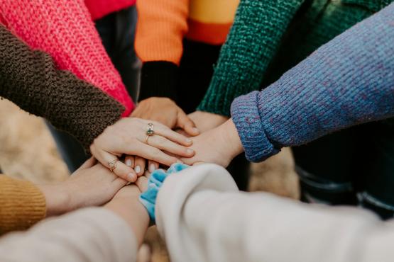 Hands together in middle of a circle